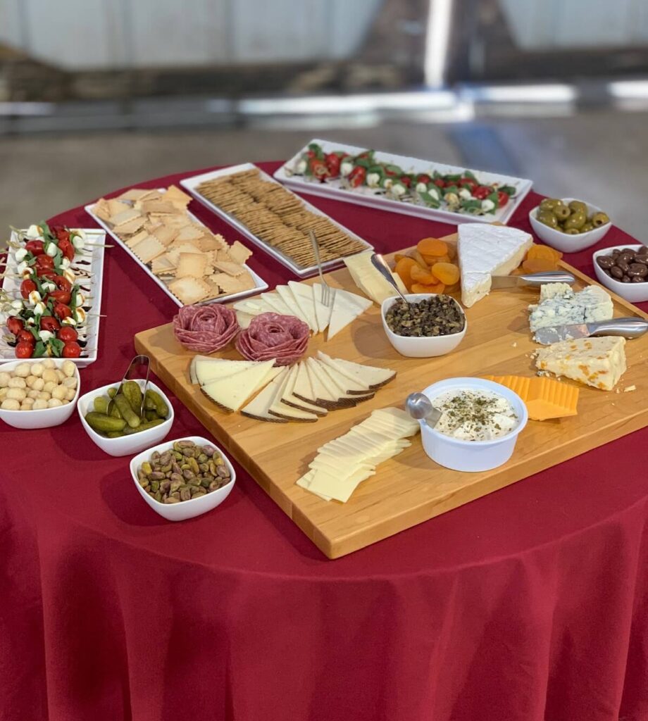 charcuterie table with wines and cheese and snacks