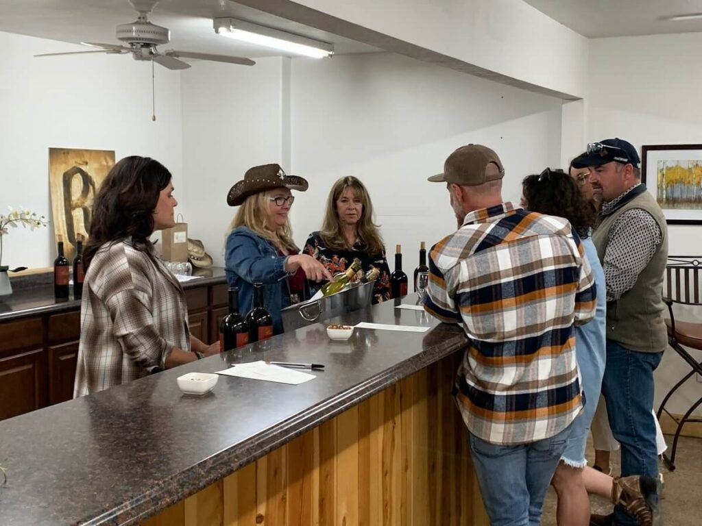 people getting wine at bar