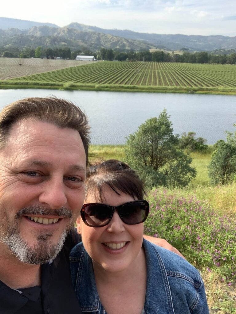 people smiling in vineyard